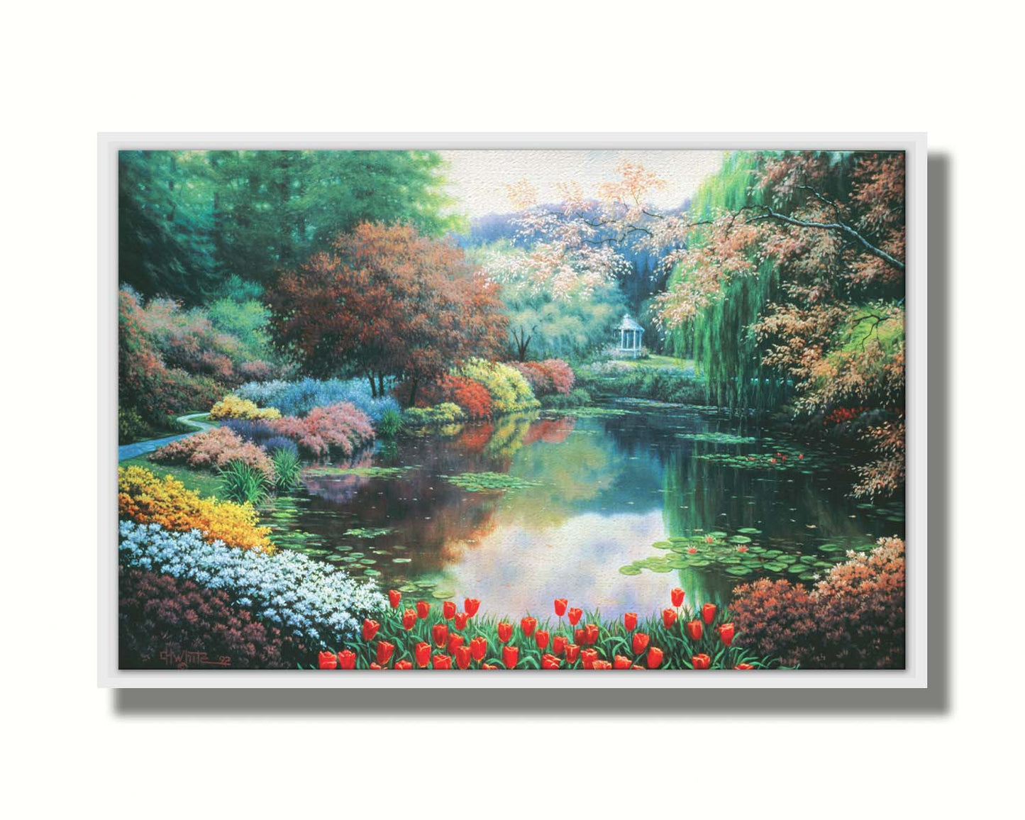 A painting of a landscape of a garden pond adorned with lily pads and vibrant flowers, with a gazebo in the distance. Printed on canvas in a float frame.