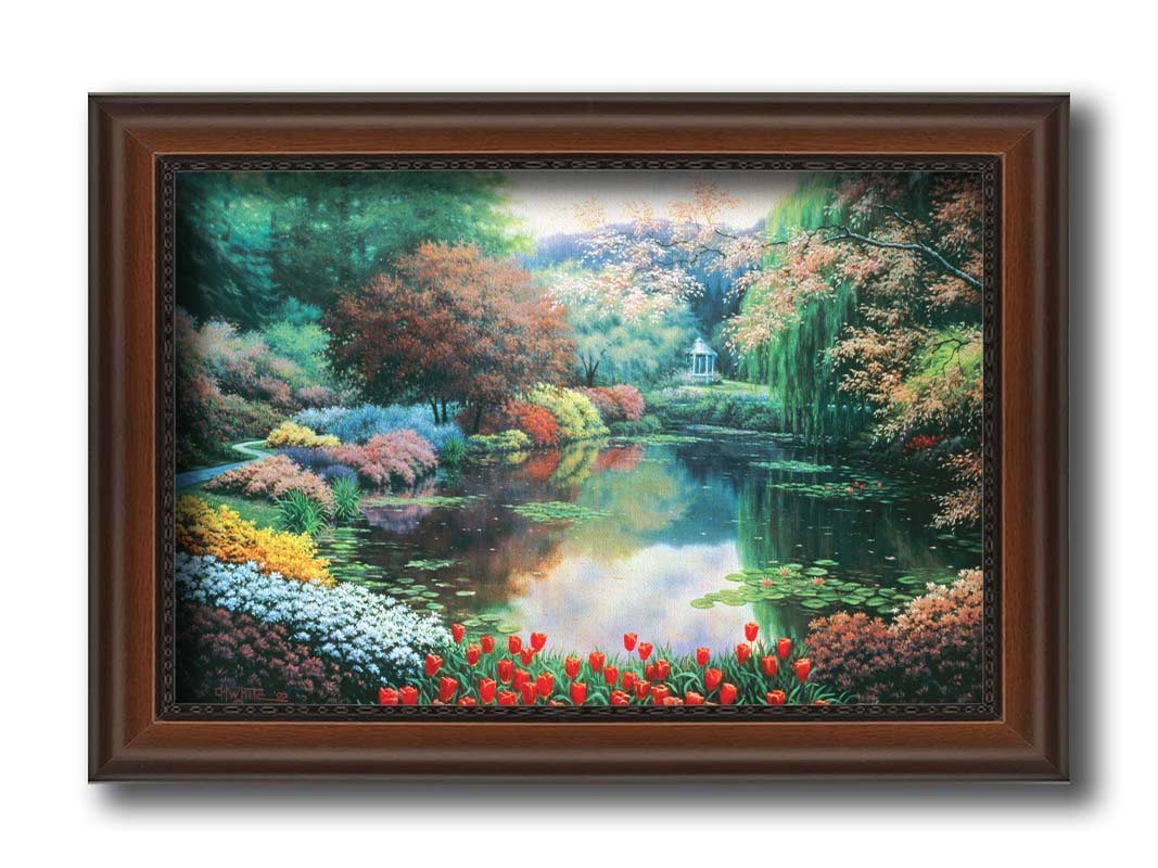 A painting of a landscape of a garden pond adorned with lily pads and vibrant flowers, with a gazebo in the distance. Printed on canvas and framed.