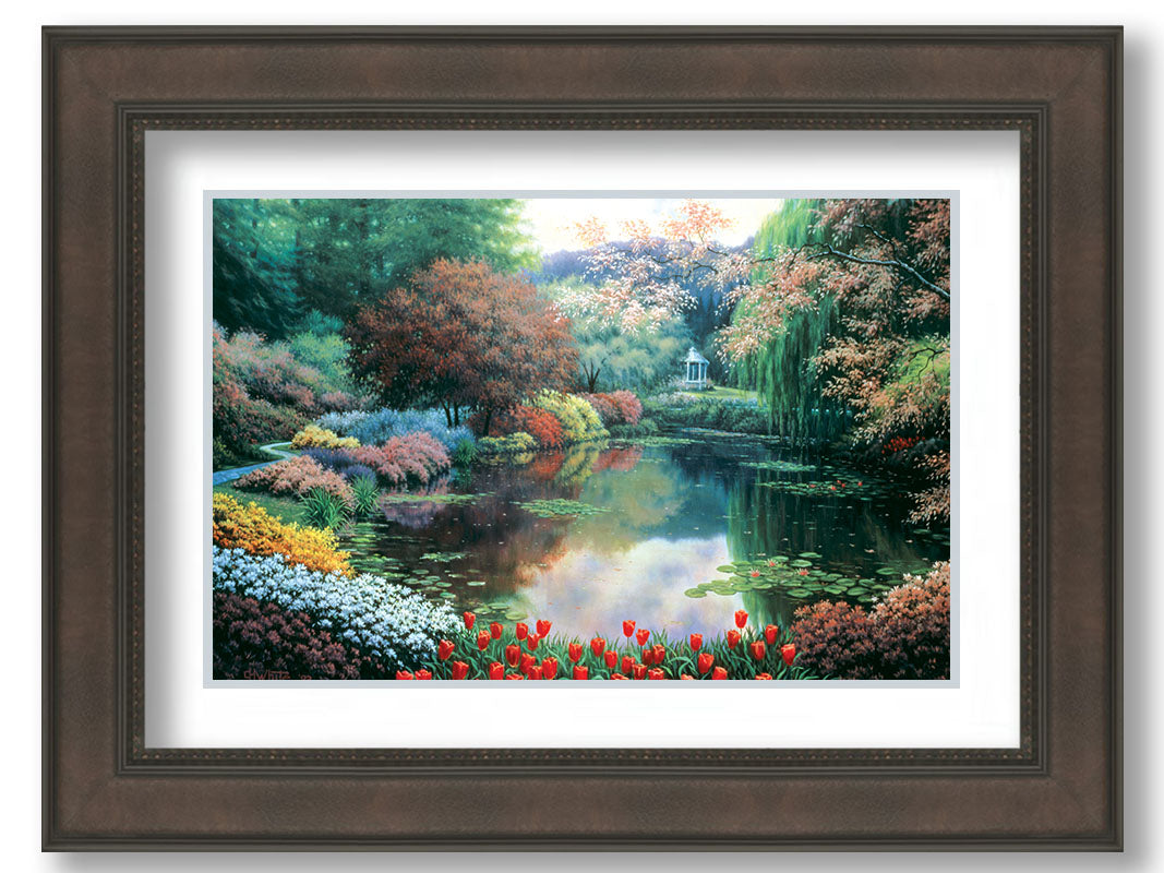 A painting of a landscape of a garden pond adorned with lily pads and vibrant flowers, with a gazebo in the distance. Printed on paper, matted, and framed.