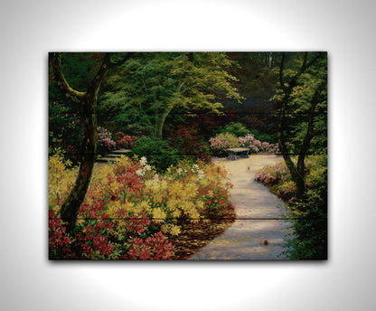 A painting of a lush garden path surrounded by vibrant red, yellow, and pink flowers and green trees. Printed on a wood pallet.