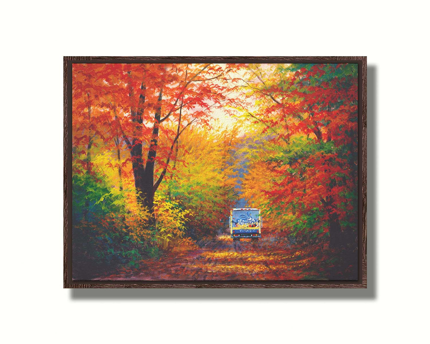 A painting of a road through the fall woods, with colorful leaves. A Schwan's food delivery truck drives away down the road. Printed on canvas in a float frame.