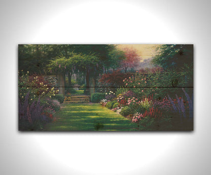 This painting depicts a grassy path leading through a tranquil garden filled with roses, carnations, lavender, and wisteria. The arch through the stone wall reveals a hidden grove of trees with a bench underneath. Printed on a wood pallet.