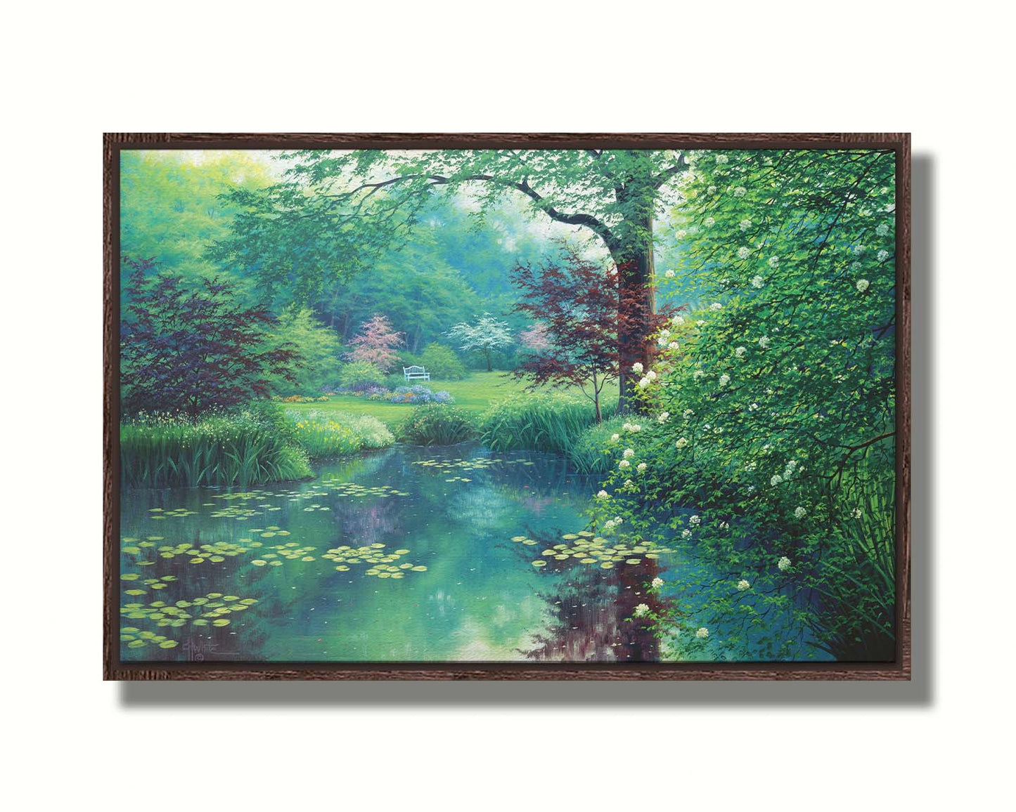 A painting of a tranquil park scene with a lilypad pond and blooming trees. Printed on canvas in a float frame.