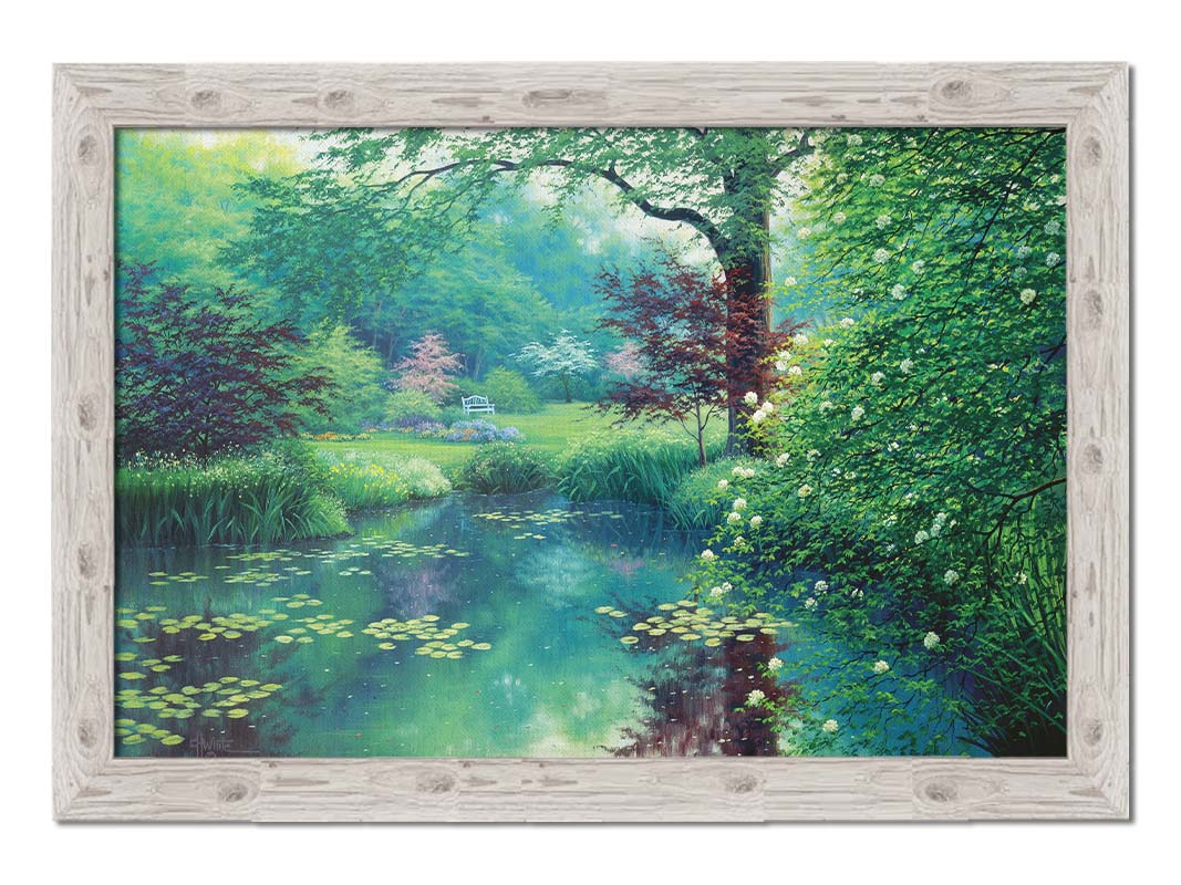 A painting of a tranquil park scene with a lilypad pond and blooming trees. Printed on canvas and framed.