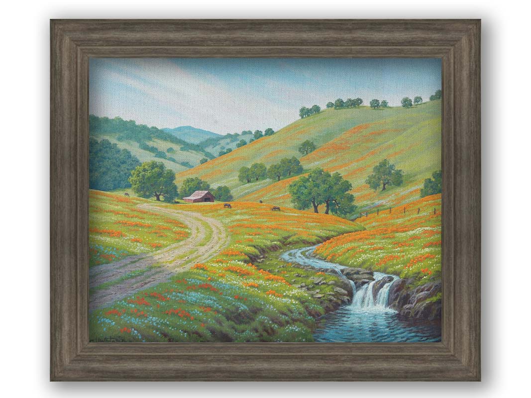 A painting of Round Valley at Mount Diablo in California. The wooded hills it is known for can be seen sprawling into the distance, with meadows of orange and white flowers. A small creek carves through the scene in parallel to a dirt path, leading up to a barn and cows. Printed on canvas and framed.