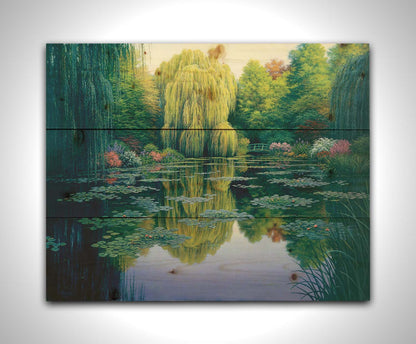 A painting of the pond at Claude Monet's garden at Giverny, France. Lily pads are scattered all across the pond, which is surrounded by willow trees and flower bushes. Printed on a wood pallet.