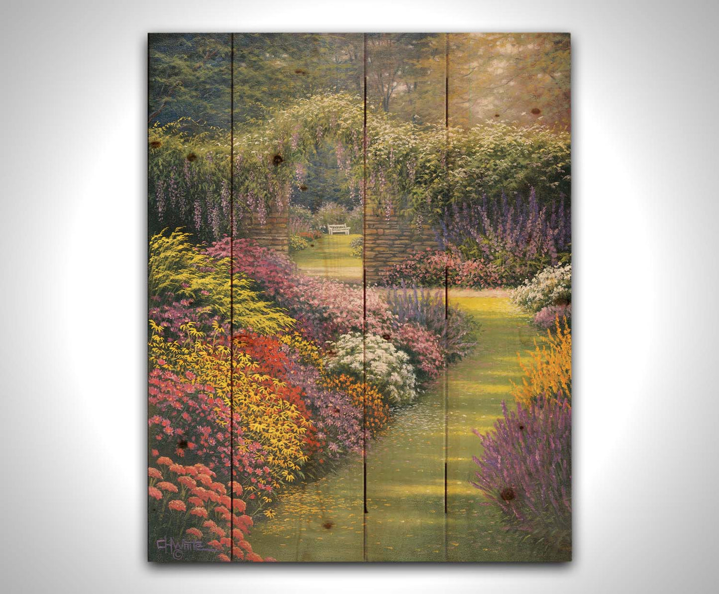 A painting of a garden path surrounded by flower bushes. The amalgam of colors leads to an archway in a stone wall, revealing a second garden area. Printed on a wood pallet.