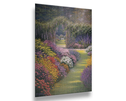 A painting of a garden path surrounded by flower bushes. The amalgam of colors leads to an archway in a stone wall, revealing a second garden area. Printed on metal.