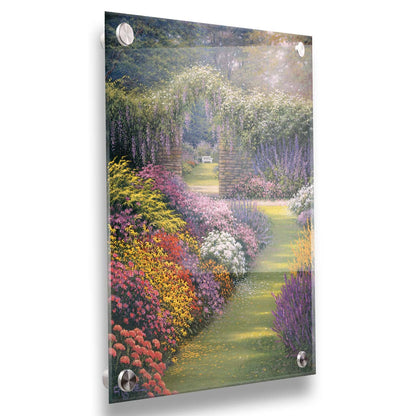 A painting of a garden path surrounded by flower bushes. The amalgam of colors leads to an archway in a stone wall, revealing a second garden area. Printed on acrylic.