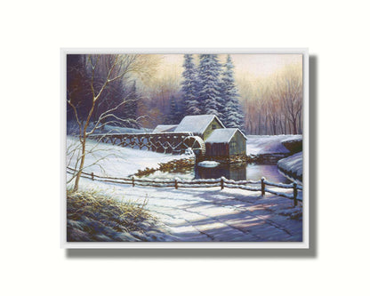 A painting of a snowy landscape centered around an old watermill, built between a country road and a forest. Pritned on canvas in a float frame.