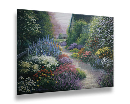 A painting of a gravel path through a garden with dense, colorful growths of flowers. The path and garden borders lead to cozy cottages. Printed on metal.