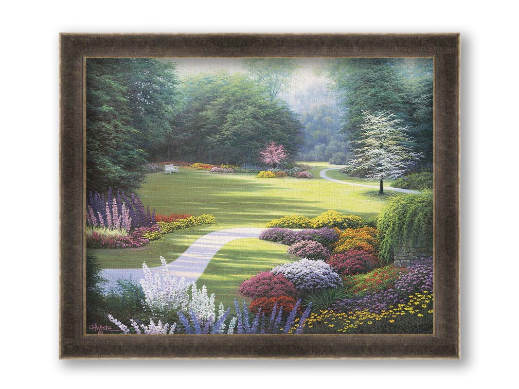 A painting of a sunny park. The open space of the grassy lawn is bordered by an abundance of colorful flowers and surrounding by trees. Printed on canvas and framed.