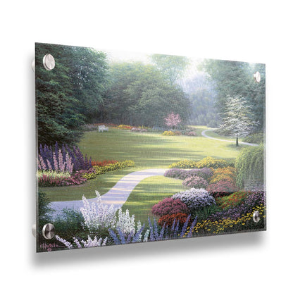 A painting of a sunny park. The open space of the grassy lawn is bordered by an abundance of colorful flowers and surrounding by trees. Printed on acrylic.