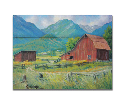 A painting of a red barn and shed surrounded by green pastures. Forested mountains stand tall in the background. Printed on a box board.