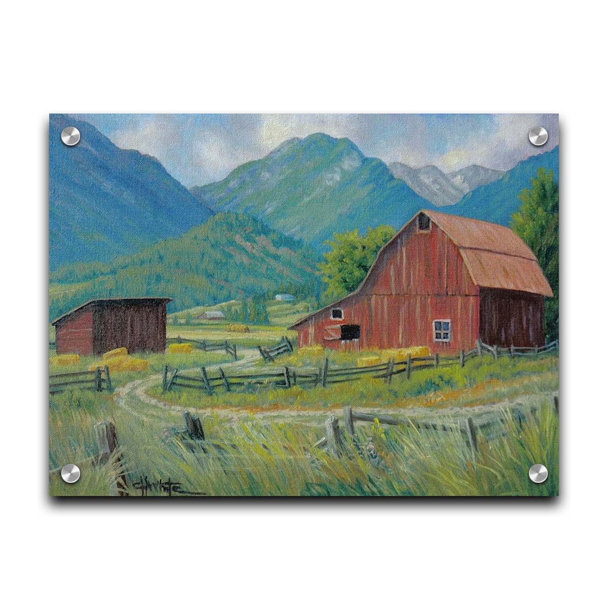 A painting of a red barn and shed surrounded by green pastures. Forested mountains stand tall in the background. Printed on acrylic.