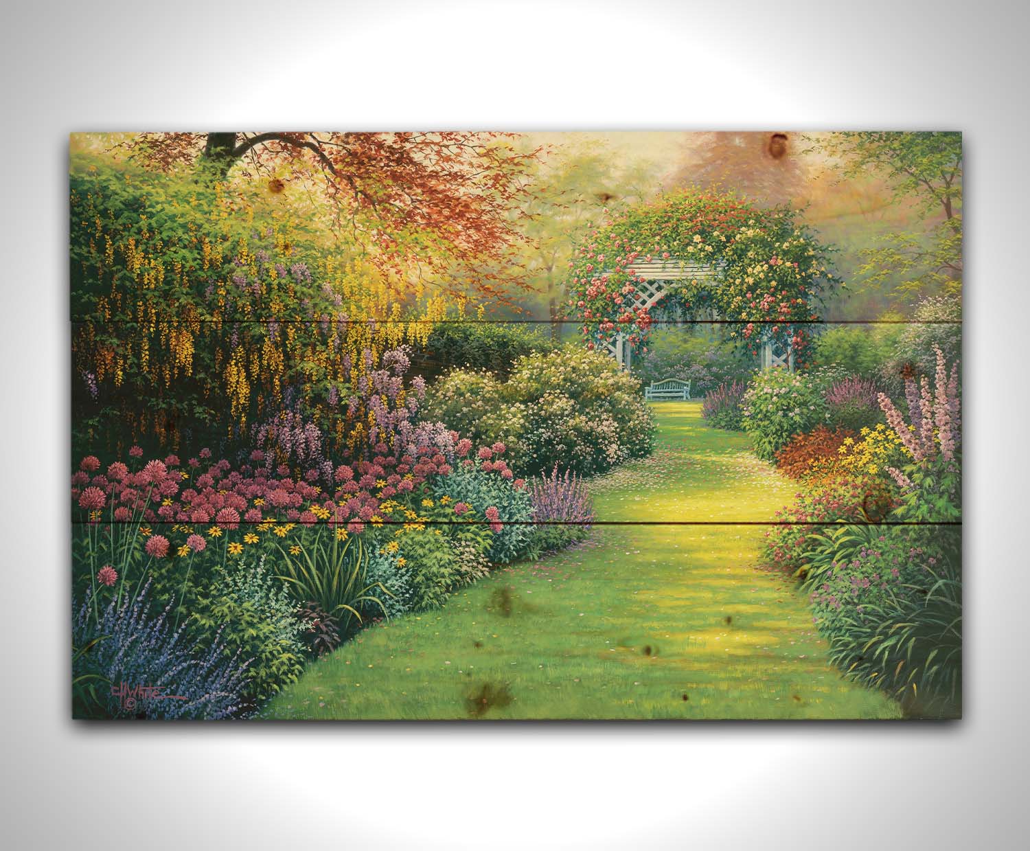 A painting of a flourishing garden with a variety of flowering plants, bordering a grass path that leads to a stunning gazebo covered in fragrant rose plants. Printed on a wood pallet.