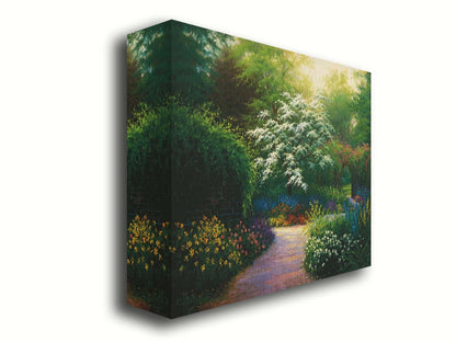 A painting of a brick wall surrounding a flower garden in a full spectrum of colors. A tree blossoming white stands central in contrast to the colorful scene. Printed on canvas.