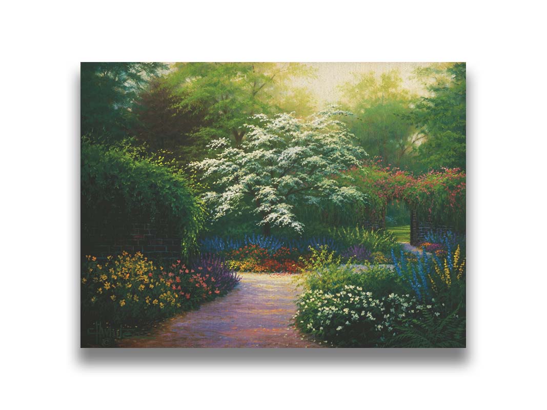 A painting of a brick wall surrounding a flower garden in a full spectrum of colors. A tree blossoming white stands central in contrast to the colorful scene. Printed on canvas.