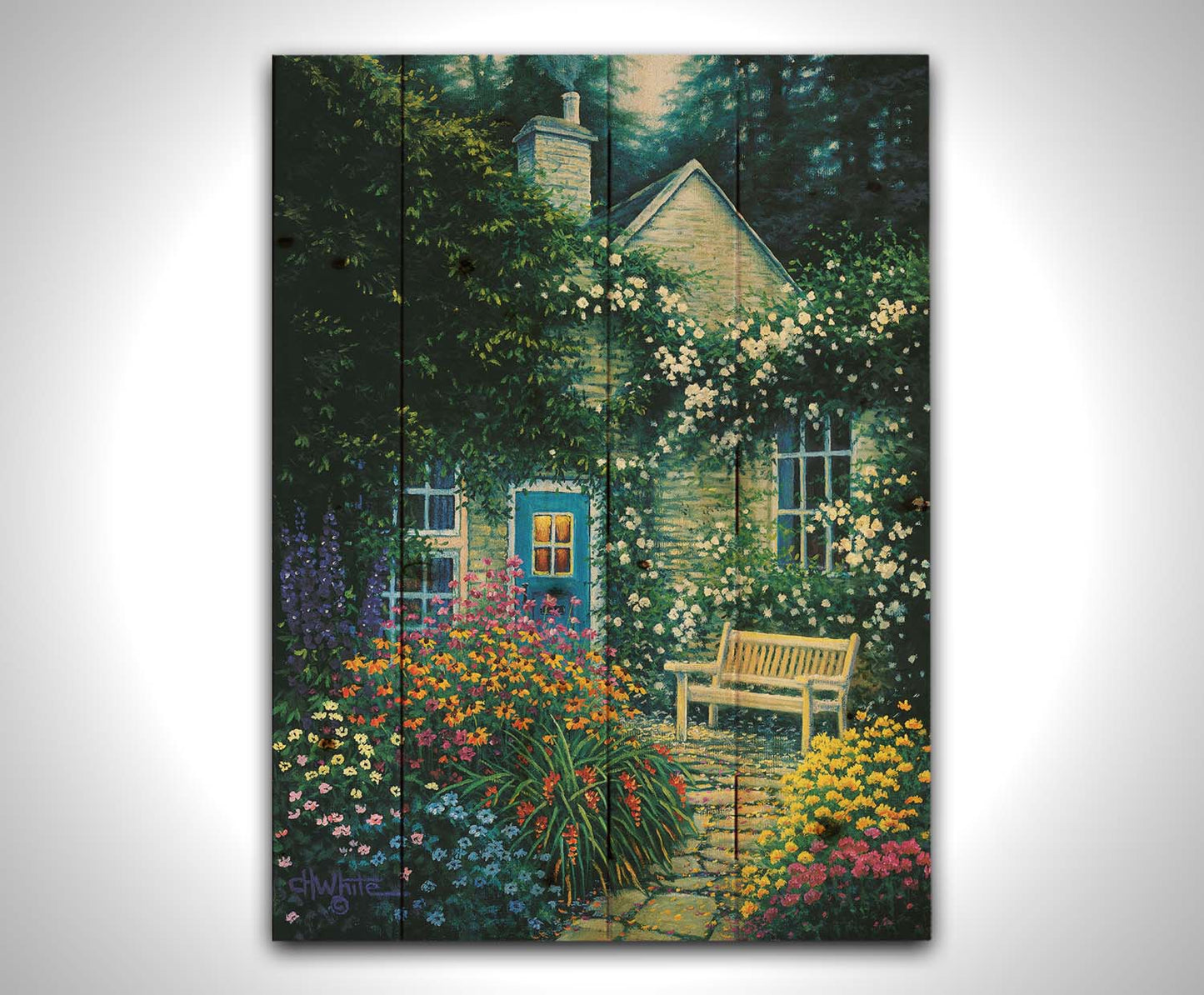 A painting of a cottage and stone path with a bench, all surrounded by colorful flower bushes and vines. Printed on a wood pallet.