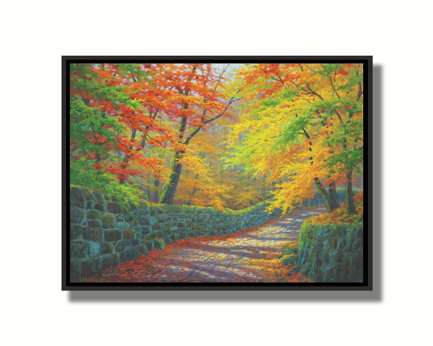 A painting of a stone road through a forest. It is bordered by stone walls on either side. The leaves of the trees are changing colors and dropping to the ground for fall. Printed on canvas in a float frame.