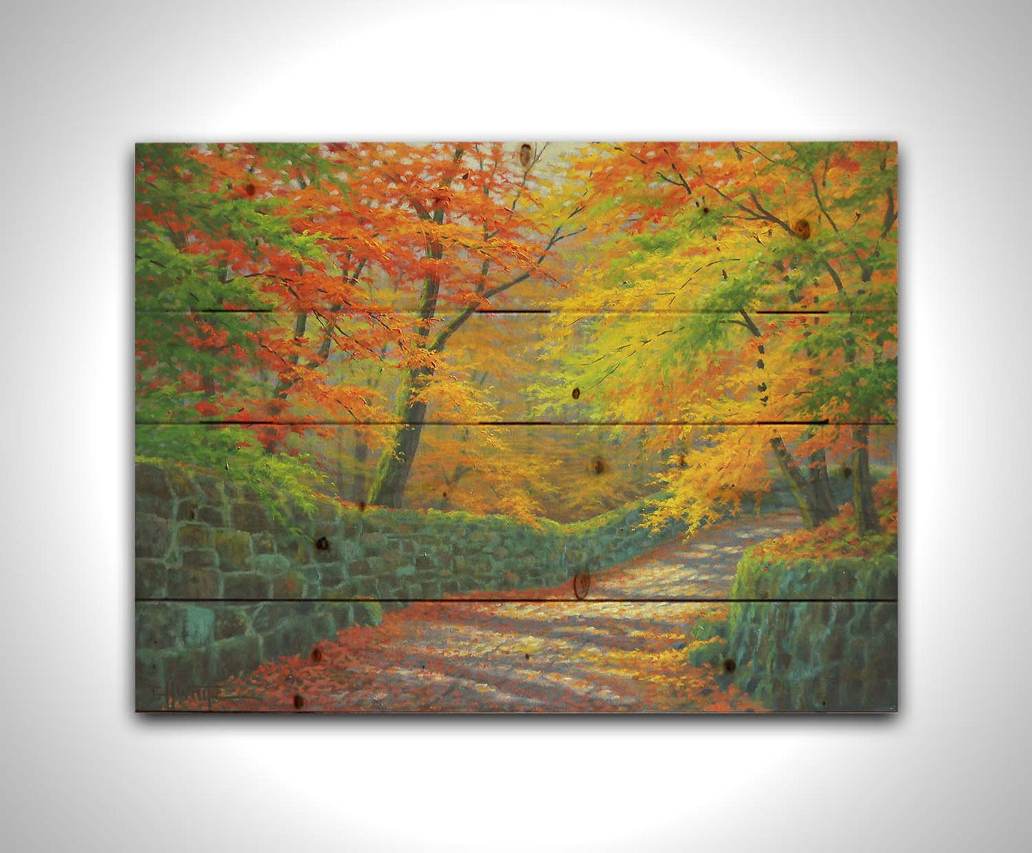 A painting of a stone road through a forest. It is bordered by stone walls on either side. The leaves of the trees are changing colors and dropping to the ground for fall. Printed on a wood pallet.