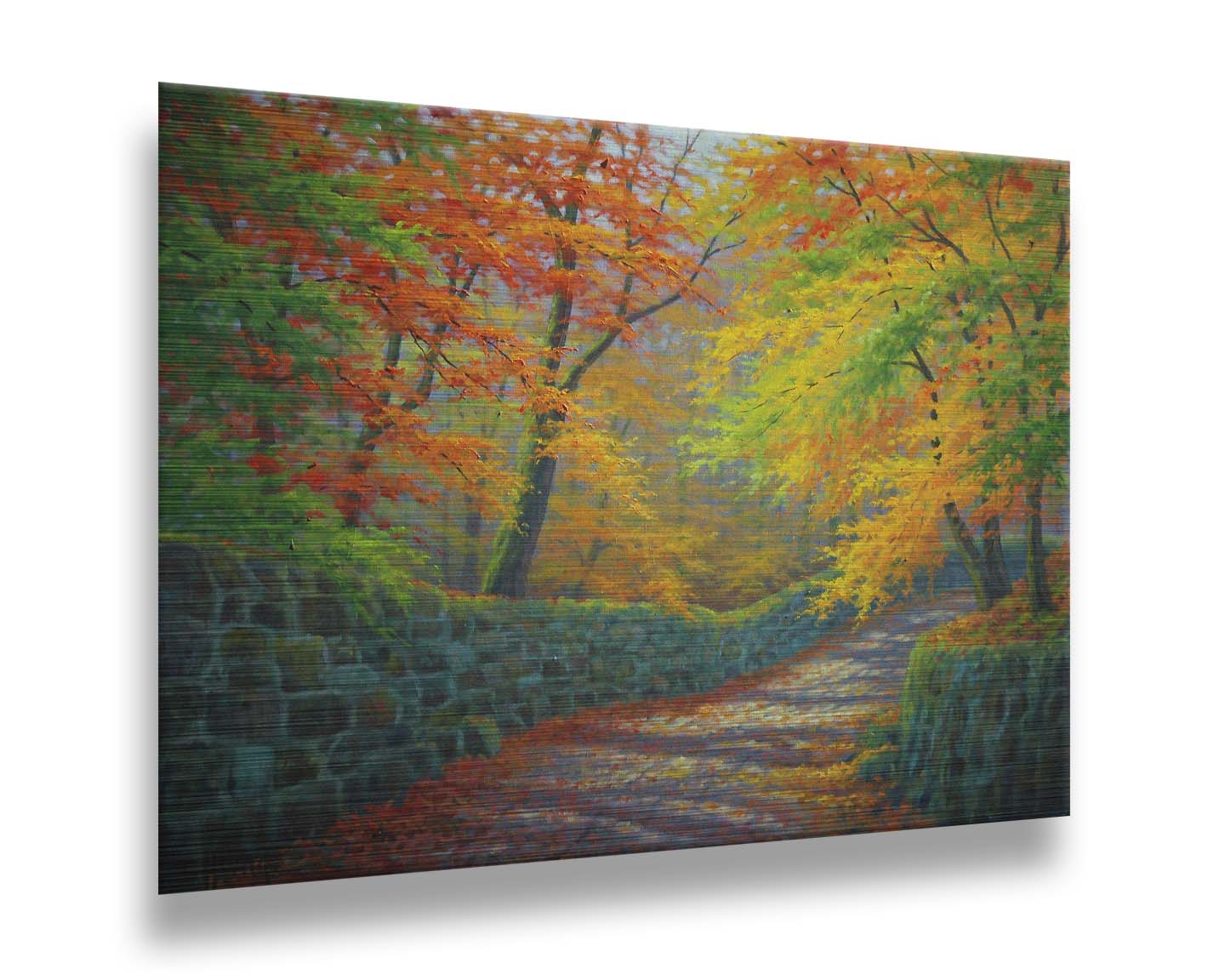 A painting of a stone road through a forest. It is bordered by stone walls on either side. The leaves of the trees are changing colors and dropping to the ground for fall. Printed on metal.