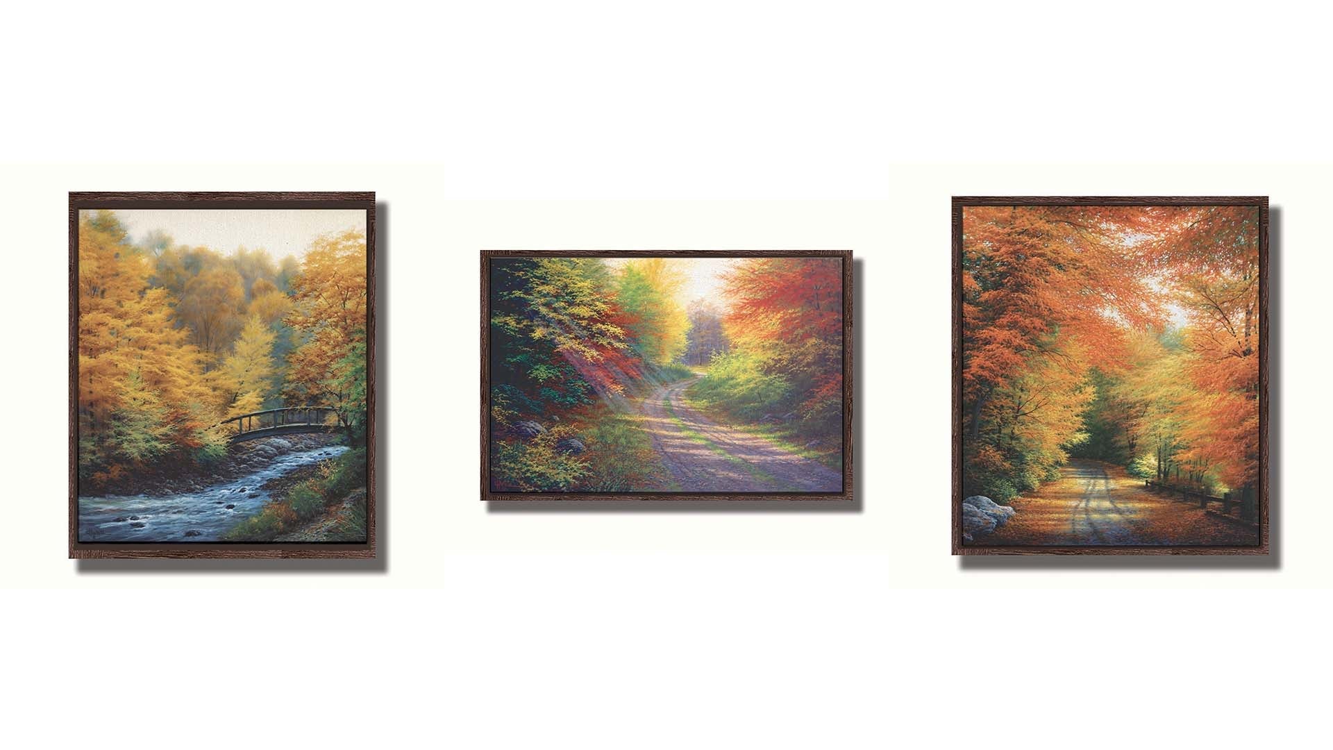 A collection of landscape paintings depicting autumn scenery. Forests of orange, yellow, red, and green trees line roads and rivers beneath white skies. Light trickles down through the leaves in a beautiful dreamlike appearance. Printed on canvas in a float frame.