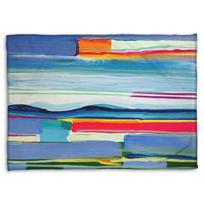 A coral fleece blanket designed with an abstract painting of colorful horizontal lines. The blue and orange are reminiscent of a sun setting over the sea. 
