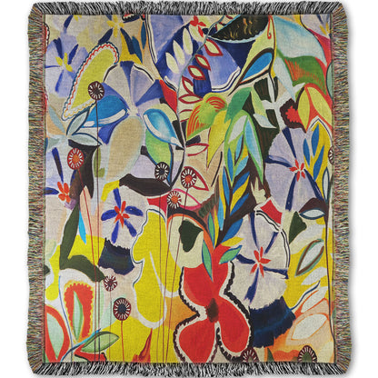 Woven throw blanket designed with an abstract painting of a variety of flowers and leaves in vibrant, flat colors.