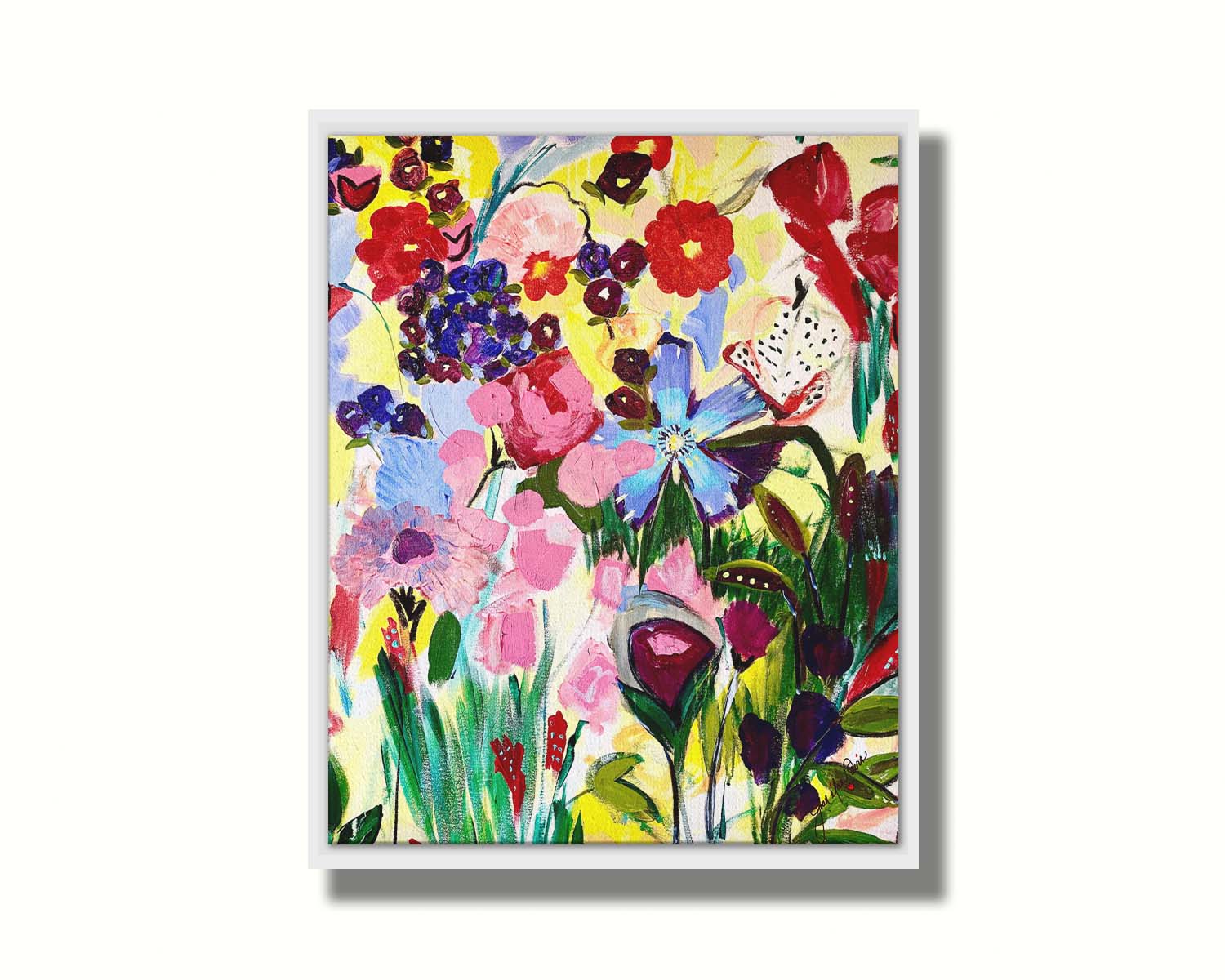 An abstract painting of a vibrant garden, simplified with flat colors and shapes. Petals in purple, red, pink, blue, and more contrast against a pale yellow background. Printed on canvas in a float frame.