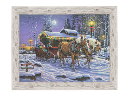 A painting of a horse-drawn sleigh, bringing people through a snowy landscape. They pass buildings around a lake decorated with Christmas lights, and their path is lit by street lamps. Printed on canvas and framed.