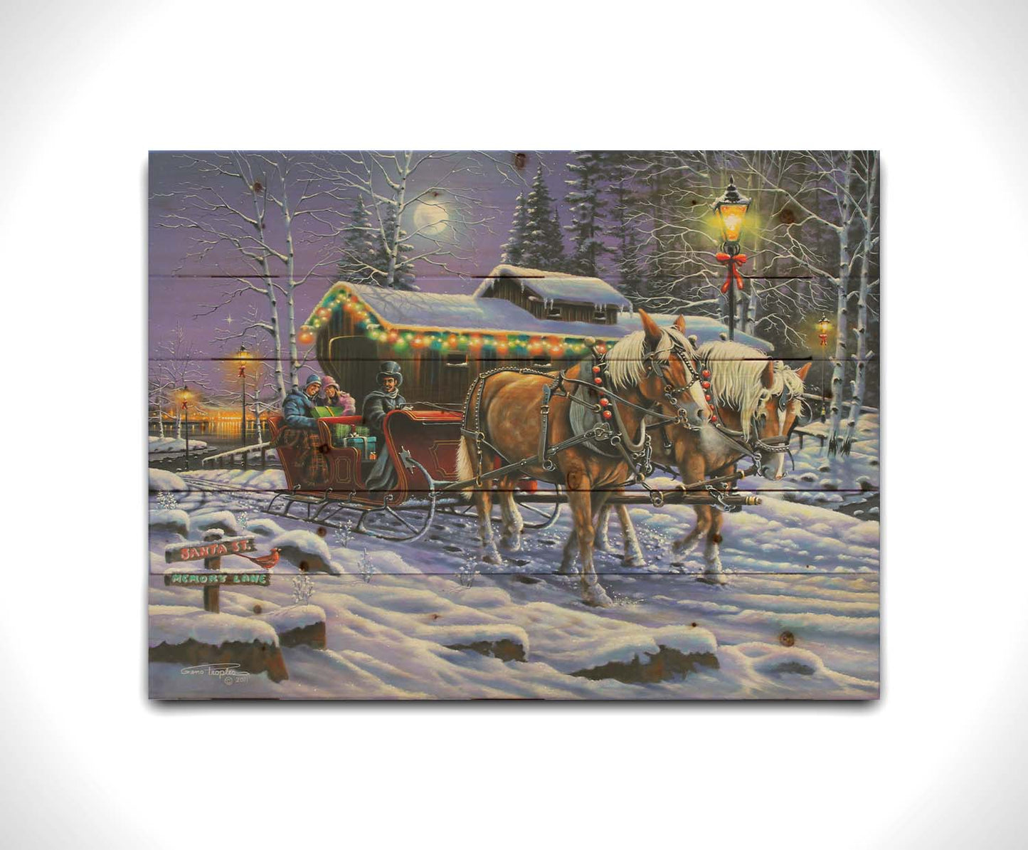 A painting of a horse-drawn sleigh, bringing people through a snowy landscape. They pass buildings around a lake decorated with Christmas lights, and their path is lit by street lamps. Printed on a wood pallet.