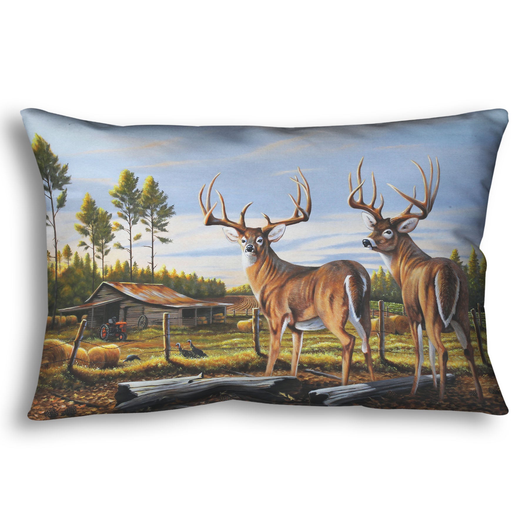 A throw pillow designed with a painting of a farm landscape, featuring two deer in the foreground. Fields, buildings, hay bales, and farming equipment can be seen beyond the fence, and fallen leaves cover the ground. 