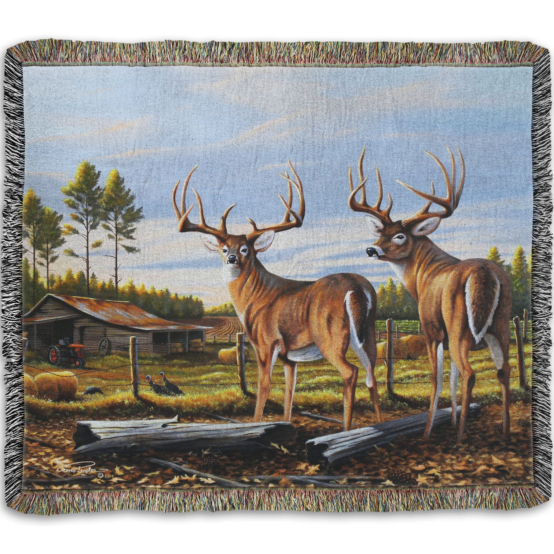 A woven throw blanket designed with a painting of a farm landscape, featuring two deer in the foreground. Fields, buildings, hay bales, and farming equipment can be seen beyond the fence, and fallen leaves cover the ground. 