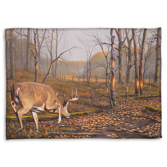 A coral fleece blanket designed with a painting of deer approaching each other in the woods. The two bucks are about to fight, as is evident by their body language.