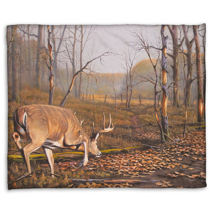 A coral fleece blanket designed with a painting of deer approaching each other in the woods. The two bucks are about to fight, as is evident by their body language.
