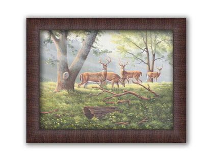 A painting of four deer in a grassy forest landscape, with beams of sunlight pouring down through the branches. Printed on canvas and framed.