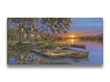 A painting of an American lakeside cabin at sunset, with boats on the water and geese overhead. Printed on canvas.