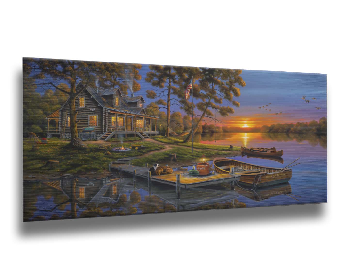 A painting of an American lakeside cabin at sunset, with boats on the water and geese overhead. Printed on metal.