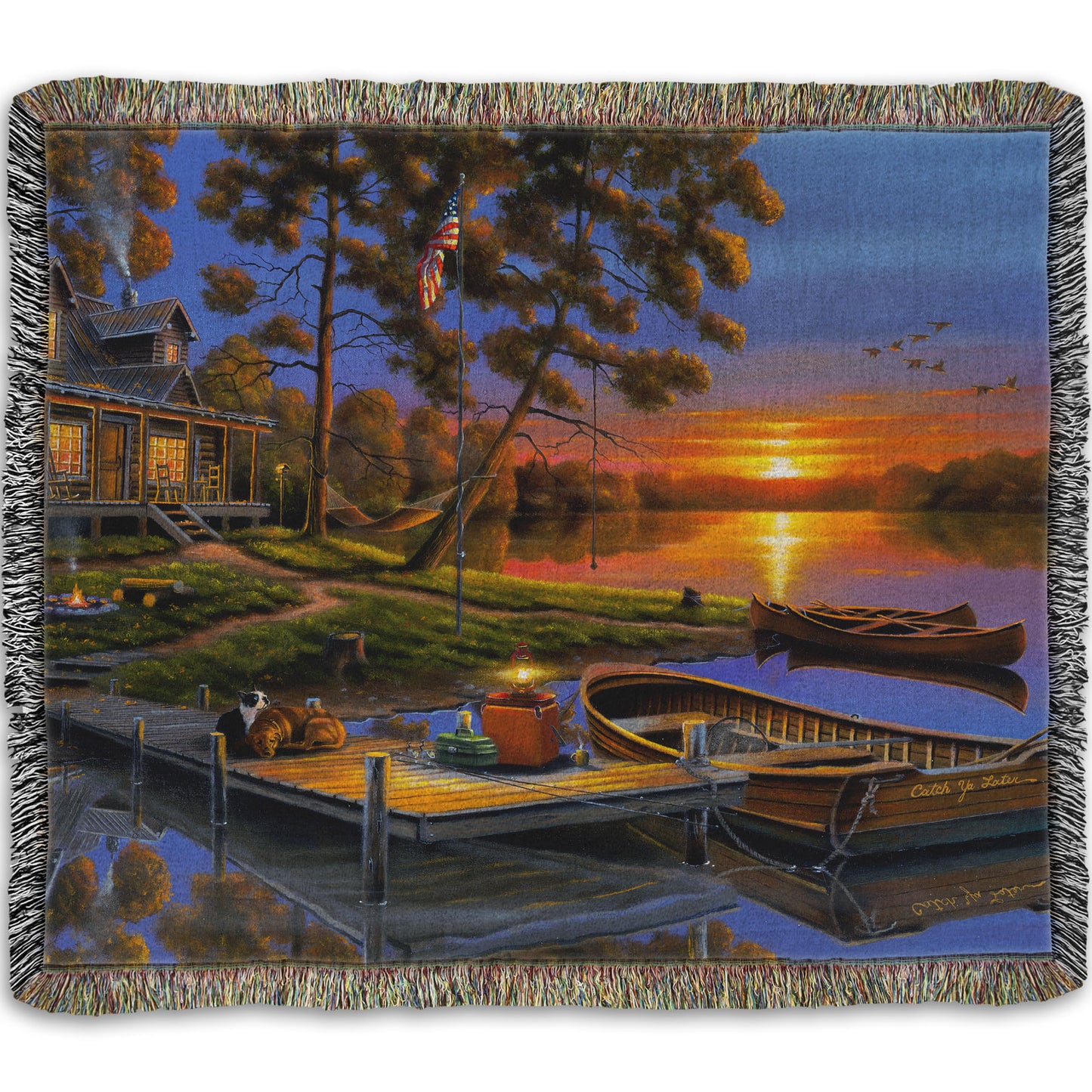 A woven throw blanket designed with a painting of an American lakeside cabin at sunset, with boats on the water and geese overhead.