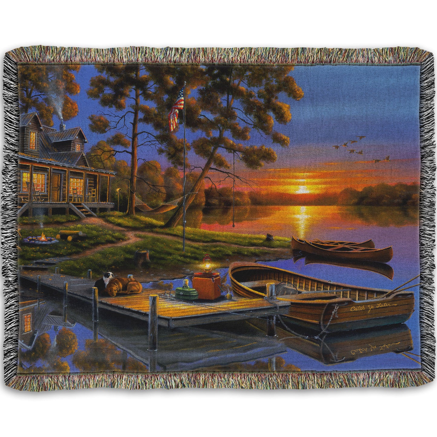A woven throw blanket designed with a painting of an American lakeside cabin at sunset, with boats on the water and geese overhead.