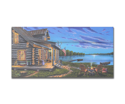 A painting of a lakeside cabin at moonrise. A stone path leads from the porch to a small campfire, as well as down to a dock where canoes rest on the water. Printed on a box board.