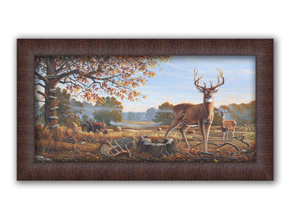 A painting of two deer standing in a foggy field, where the hay has been cut and baled. There is an empty hunting stand atop the tree behind them. Printed on canvas and framed.