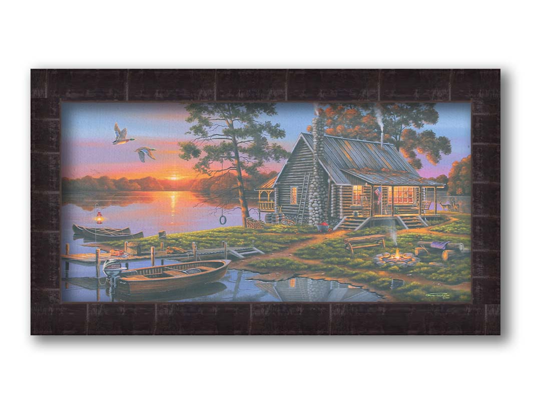 A painting of a lakeside cabin in a deciduous forest of the United States. The sunset is reflected by the water, where several small boats are docked. A lit campfire, deer, geese, and dog bring extra life to the scene. Printed on canvas and framed.