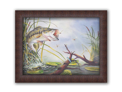 A painting of a largemouth bass leaping out of the water to catch a dragonfly. A fishing line and hook are stuck nearby, wrapped around a branch in the water. Printed on canvas and framed.