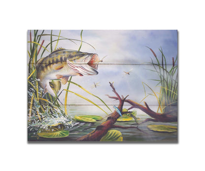 A painting of a largemouth bass leaping out of the water to catch a dragonfly. A fishing line and hook are stuck nearby, wrapped around a branch in the water. Printed on a box board.