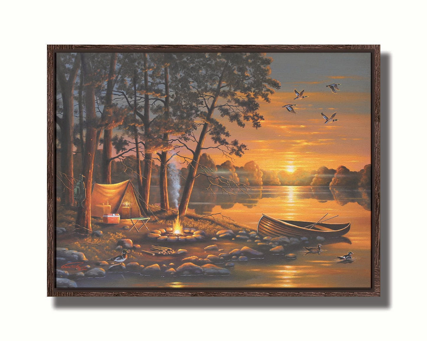 A painting of a small woods campsite at the edge of a lake. A boat is docked on the rocks of the shore, and a campfire is lit nearby. Some ducks swim in the lake as others fly overhead before the setting sun. Printed on canvas in a float frame.