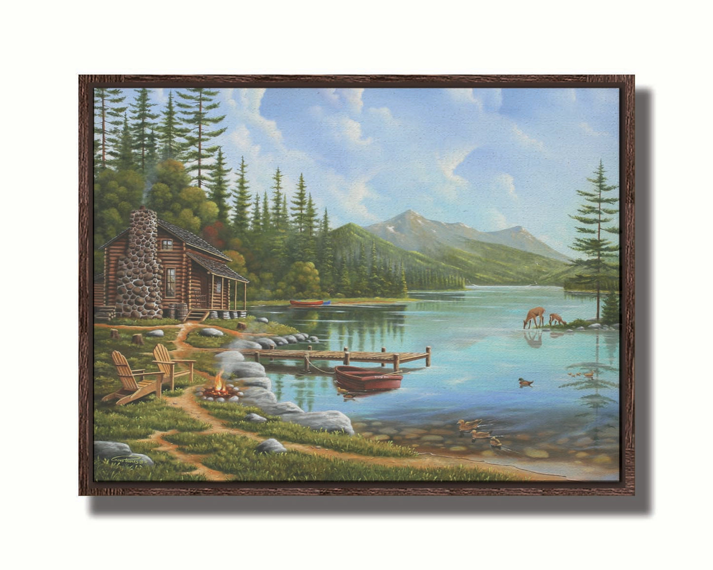 A painting of a lakeside cabin on a sunny day. Boats can be seen on the water, which reflects the mountains in the distance. Deer drink from the lake, where ducks are swimming. Wood chairs surround a small campfire on the shore nearby. Printed on canvas in a float frame.