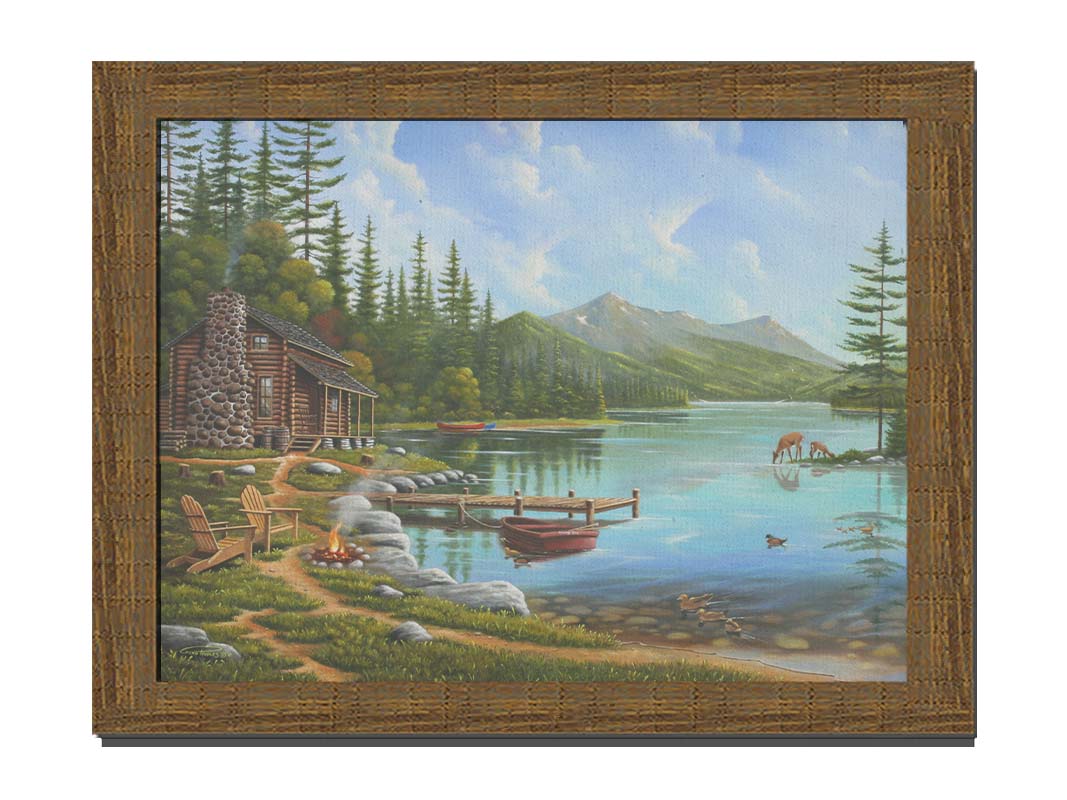 A painting of a lakeside cabin on a sunny day. Boats can be seen on the water, which reflects the mountains in the distance. Deer drink from the lake, where ducks are swimming. Wood chairs surround a small campfire on the shore nearby. Printed on canvas and framed.