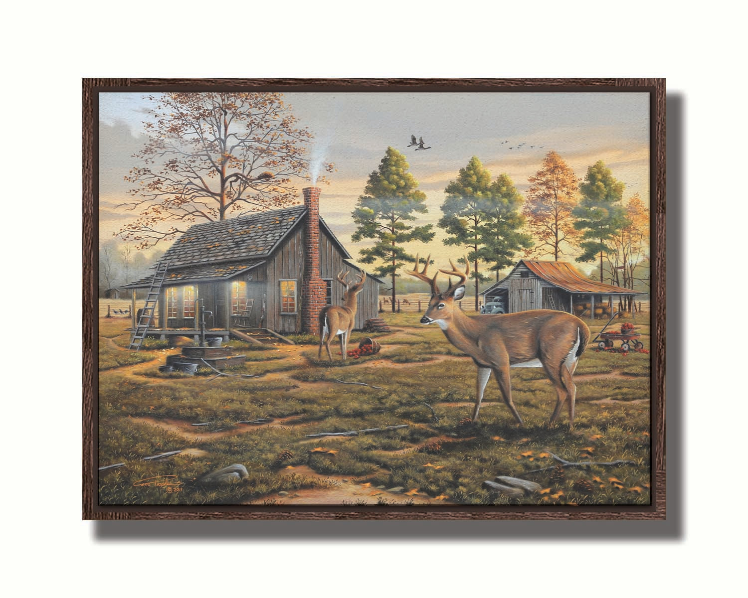 A painting of a farmhouse scene, featuring a fenced field, wood cabin, and an accompanying shed. In the foreground, deer are eating apples from wagons and baskets in the yard. Printed on canvas in a float frame.